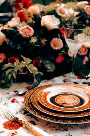 beautiful plate and fresh perfect colorful flowers standing on luxury tableの写真素材