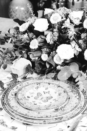 beautiful plate and fresh perfect colorful flowers standing on luxury tableの写真素材
