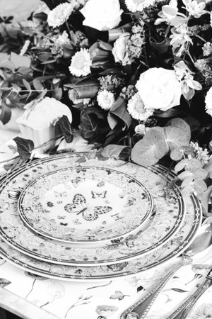 beautiful plate and fresh perfect colorful flowers standing on luxury table