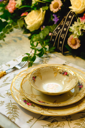 beautiful plate and fresh perfect colorful flowers standing on luxury tableの写真素材
