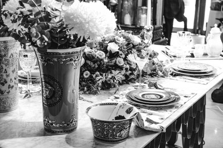 beautiful plate and fresh perfect colorful flowers standing on luxury tableの写真素材