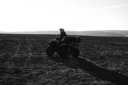 helmet sitting on atv quad bike in mountainsの写真素材