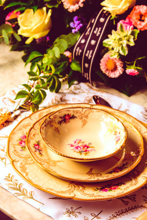 beautiful plate and fresh perfect colorful flowers standing on luxury tableの写真素材