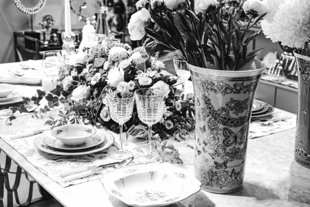 beautiful plate and fresh perfect colorful flowers standing on luxury table