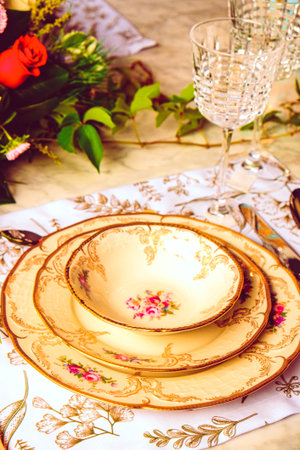 beautiful plate and fresh perfect colorful flowers standing on luxury tableの写真素材