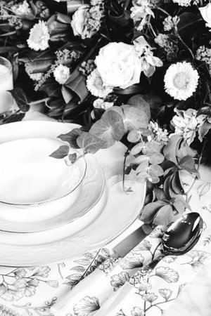 beautiful plate and fresh perfect colorful flowers standing on luxury tableの写真素材