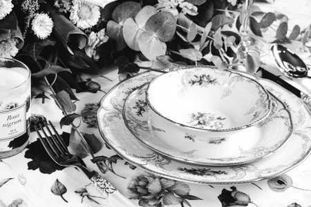 beautiful plate and fresh perfect colorful flowers standing on luxury tableの写真素材