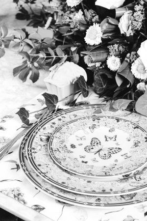 beautiful plate and fresh perfect colorful flowers standing on luxury tableの写真素材