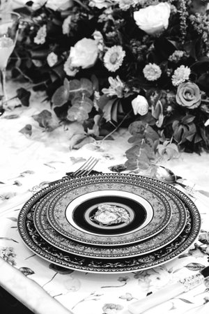 beautiful plate and fresh perfect colorful flowers standing on luxury tableの写真素材