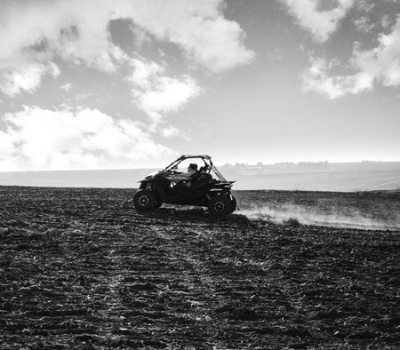 helmet sitting on atv quad bike in mountainsの写真素材