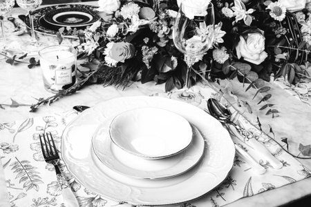 beautiful plate and fresh perfect colorful flowers standing on luxury table