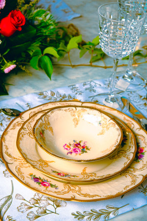 beautiful plate and fresh perfect colorful flowers standing on luxury table