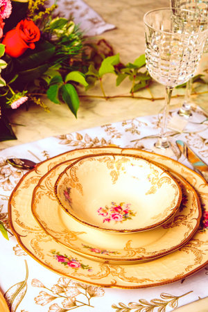 beautiful plate and fresh perfect colorful flowers standing on luxury tableの写真素材