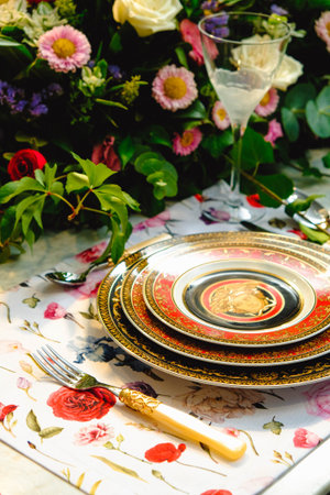 beautiful plate and fresh perfect colorful flowers standing on luxury tableの写真素材