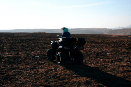 helmet sitting on atv quad bike in mountainsの写真素材