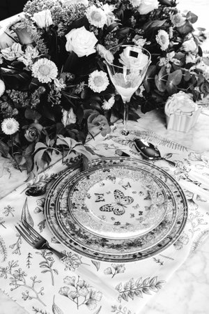 beautiful plate and fresh perfect colorful flowers standing on luxury table