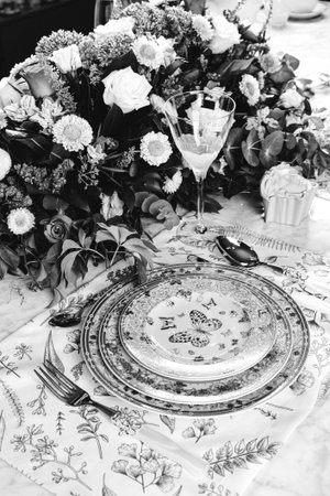 beautiful plate and fresh perfect colorful flowers standing on luxury table