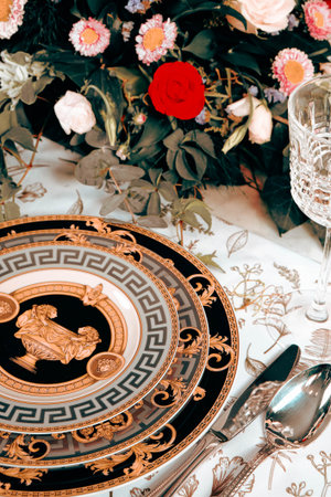 beautiful plate and fresh perfect colorful flowers standing on luxury tableの写真素材