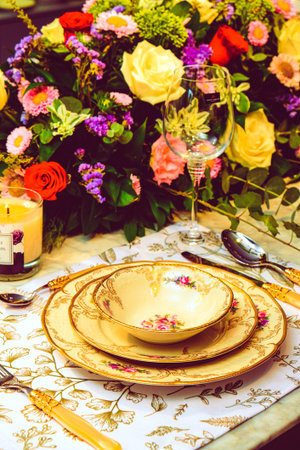 beautiful plate and fresh perfect colorful flowers standing on luxury table