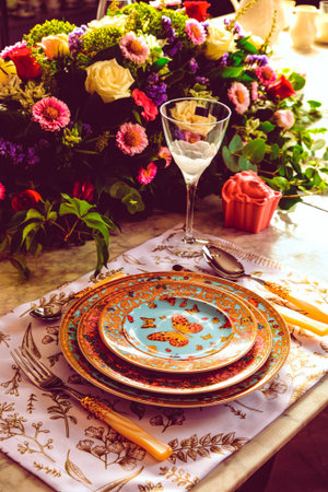 beautiful plate and fresh perfect colorful flowers standing on luxury table