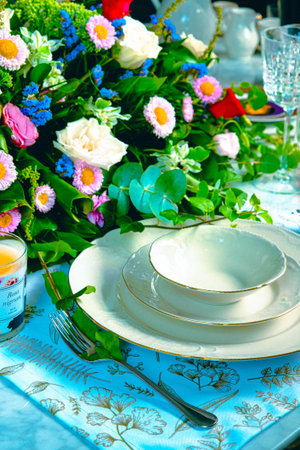 beautiful plate and fresh perfect colorful flowers standing on luxury table