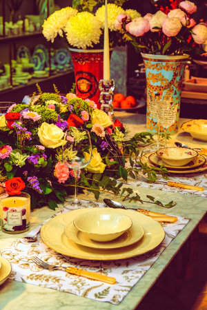 beautiful plate and fresh perfect colorful flowers standing on luxury table