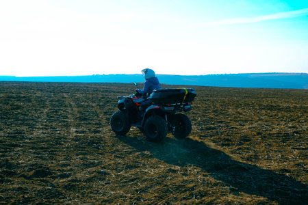 helmet sitting on atv quad bike in mountainsの写真素材