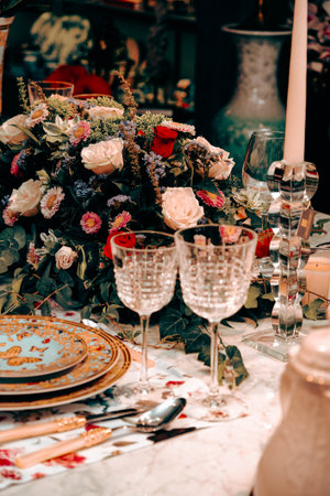 beautiful plate and fresh perfect colorful flowers standing on luxury tableの写真素材