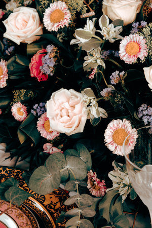 beautiful plate and fresh perfect colorful flowers standing on luxury tableの写真素材