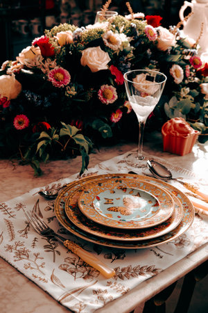 beautiful plate and fresh perfect colorful flowers standing on luxury tableの写真素材