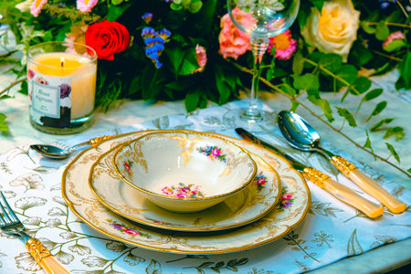 beautiful plate and fresh perfect colorful flowers standing on luxury tableの写真素材