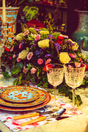 beautiful plate and fresh perfect colorful flowers standing on luxury tableの写真素材