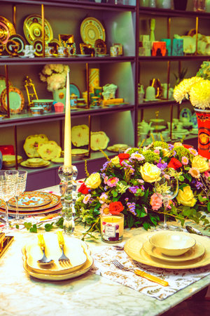 beautiful plate and fresh perfect colorful flowers standing on luxury table