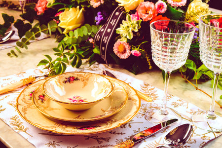 beautiful plate and fresh perfect colorful flowers standing on luxury tableの写真素材