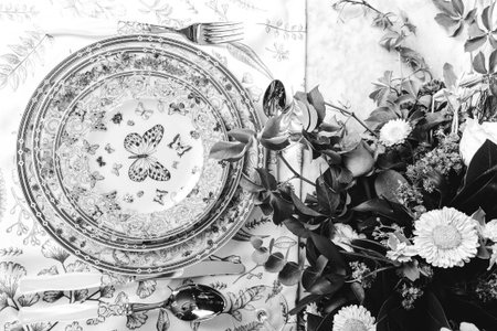 beautiful plate and fresh perfect colorful flowers standing on luxury tableの写真素材