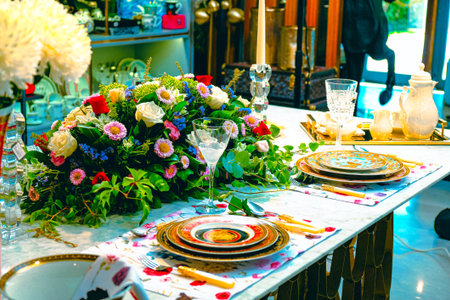 beautiful plate and fresh perfect colorful flowers standing on luxury tableの写真素材