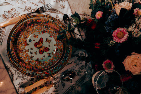 beautiful plate and fresh perfect colorful flowers standing on luxury tableの写真素材