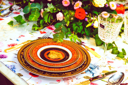 beautiful plate and fresh perfect colorful flowers standing on luxury table