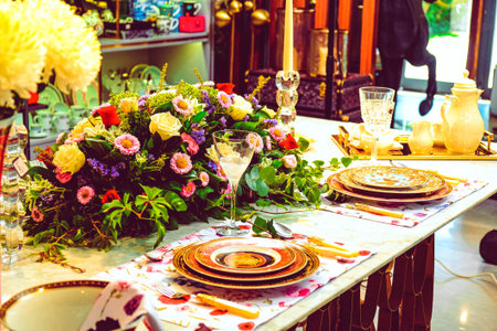 beautiful plate and fresh perfect colorful flowers standing on luxury table