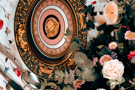 beautiful plate and fresh perfect colorful flowers standing on luxury tableの写真素材