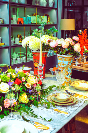 beautiful plate and fresh perfect colorful flowers standing on luxury tableの写真素材