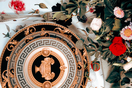 beautiful plate and fresh perfect colorful flowers standing on luxury tableの写真素材