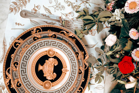 beautiful plate and fresh perfect colorful flowers standing on luxury tableの写真素材