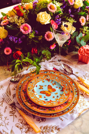 beautiful plate and fresh perfect colorful flowers standing on luxury tableの写真素材