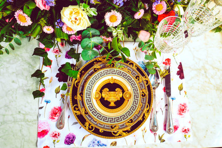 beautiful plate and fresh perfect colorful flowers standing on luxury table