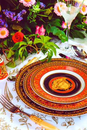 beautiful plate and fresh perfect colorful flowers standing on luxury table