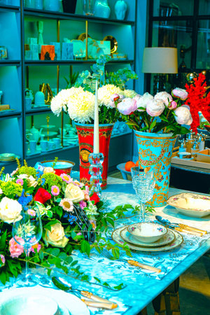 beautiful plate and fresh perfect colorful flowers standing on luxury table
