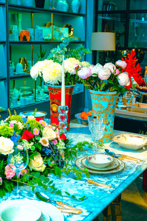 beautiful plate and fresh perfect colorful flowers standing on luxury tableの写真素材