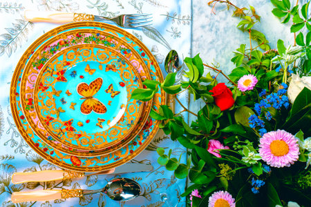beautiful plate and fresh perfect colorful flowers standing on luxury tableの写真素材