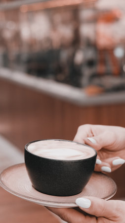 A steaming cup of coffee on the tableの写真素材